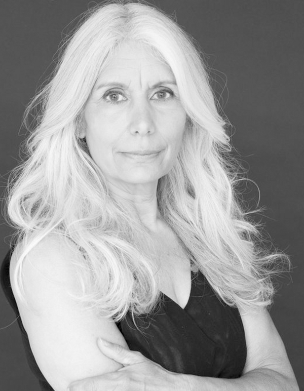 Jani's black & white headshot: a Méti woman with long white hair around her shoulders wearing a simple black top. Photo by Helen Tansey.