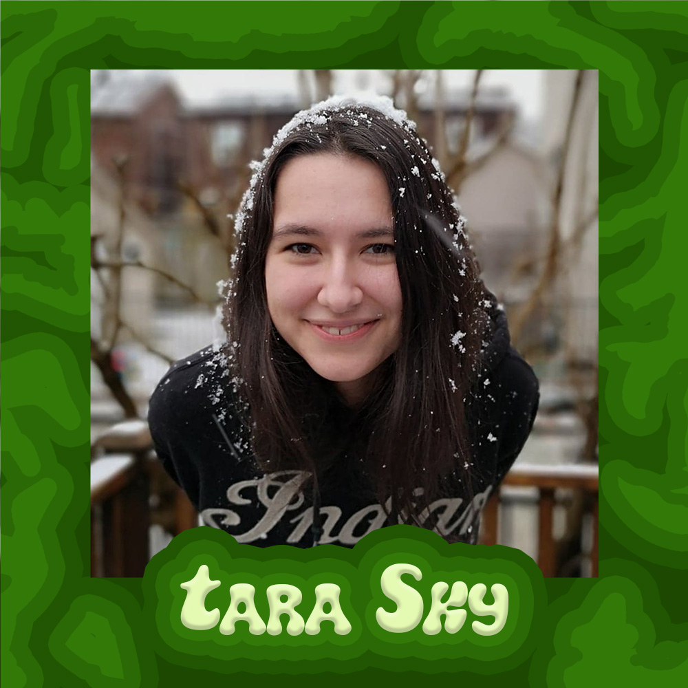 Tara is a mixed White/Indigenous genderqueer person in their 20’s with medium long brown hair and bangs. They are on the taller side at 5”8’. Her picture is surrounded by a border of darker greens and her name in light green bubbly letters.